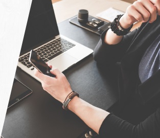 Person looking at phone at their desk